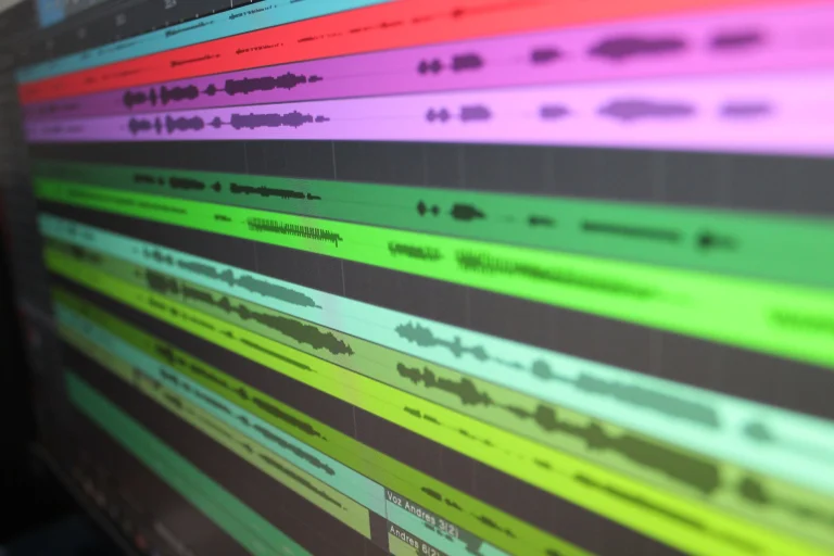 Close-up of audio waveforms on screen, showcasing music production software in use — an editorial image for "Auto-Tune, Production Tools, and the Sound of Modern Pop."