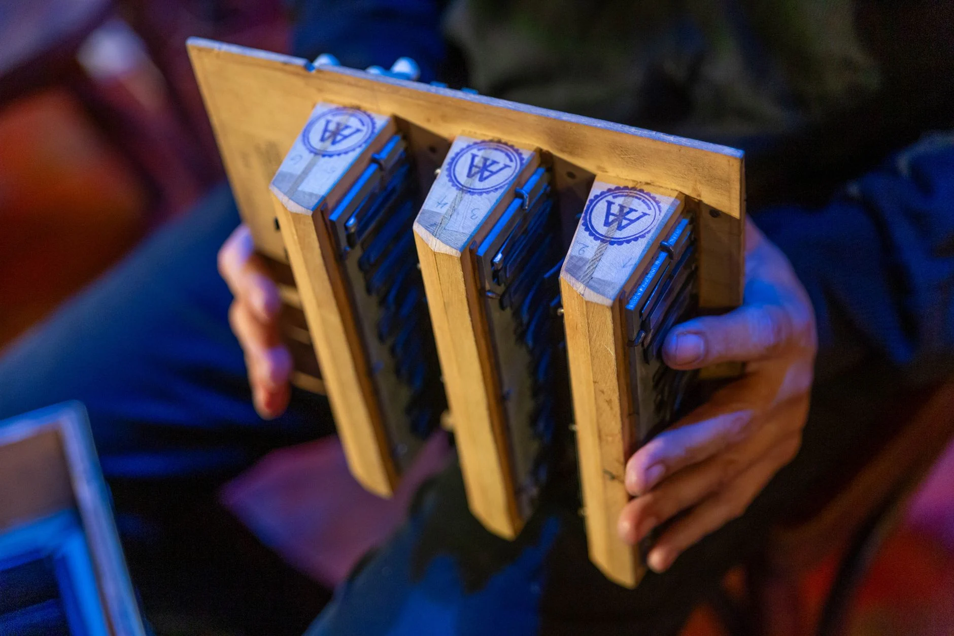 Close-up of a musician holding harmonicas during a live performance in Mar del Plata — an editorial image for "Bob Dylan: Songwriting, Reinvention, and Influence."