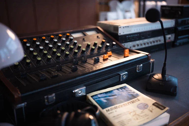 Close-up of a vintage audio mixer with a microphone and recording equipment on a desk — an editorial image for "How the Motown Sound Was Created."