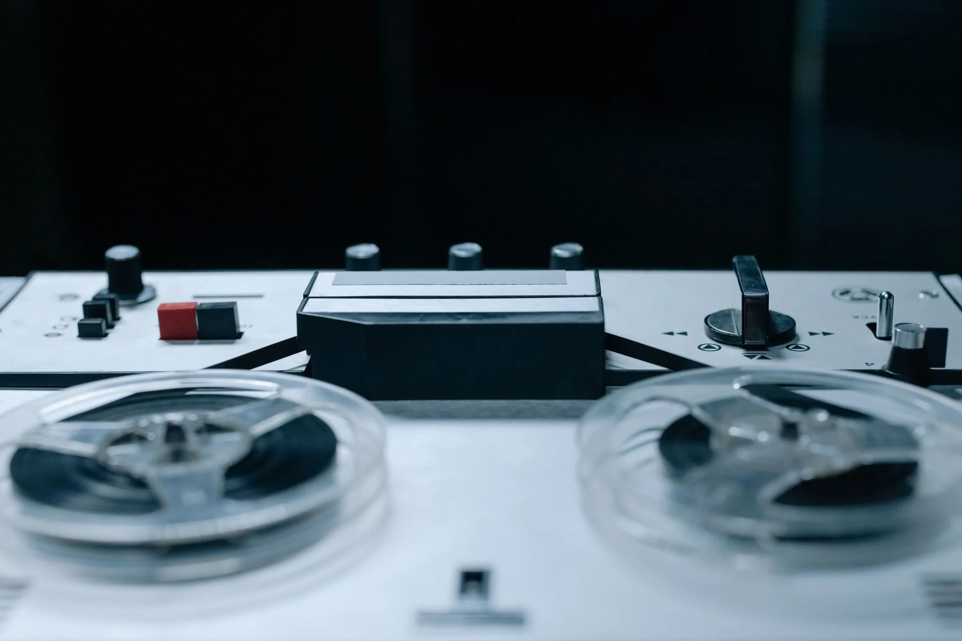 Close-up image of a vintage reel-to-reel audio recorder with control buttons and tape reels — an editorial image for "Like a Rolling Stone and the Expansion of the Pop Song."