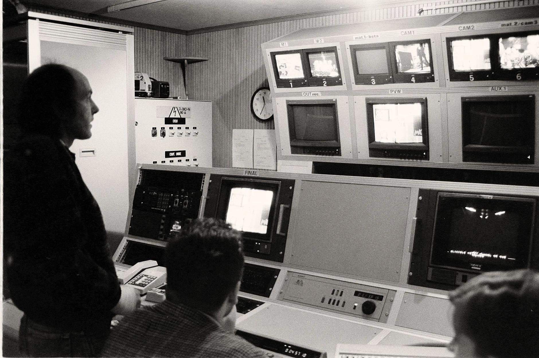 Men working in a vintage broadcasting control room filled with analogue equipment and monitors — an editorial image for "MTV and the Music Video Revolution."