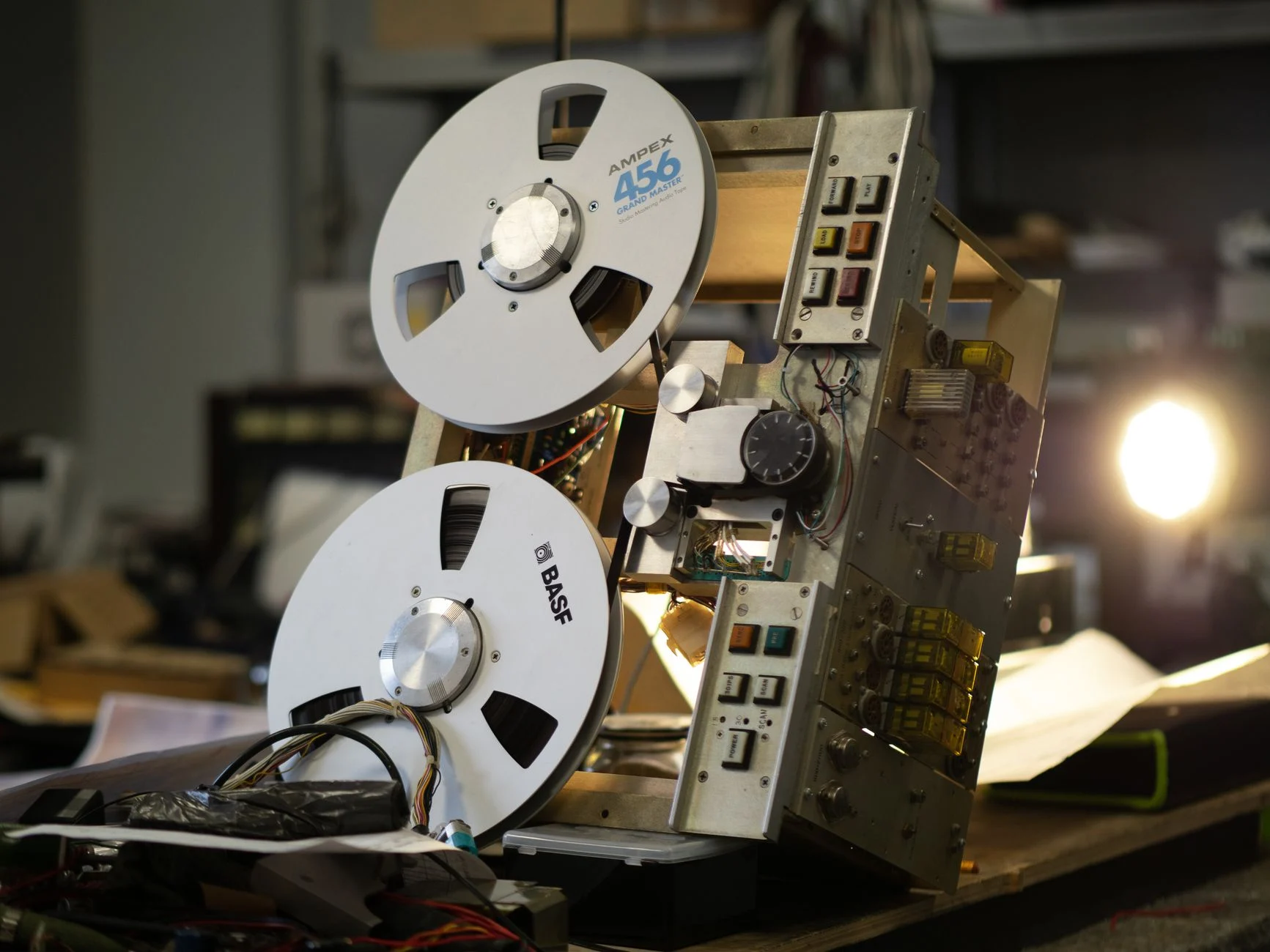Close-up of a classic reel-to-reel tape recorder in a vintage recording studio setting — an editorial image for "How Multitrack Recording Technology Changed Songwriting."