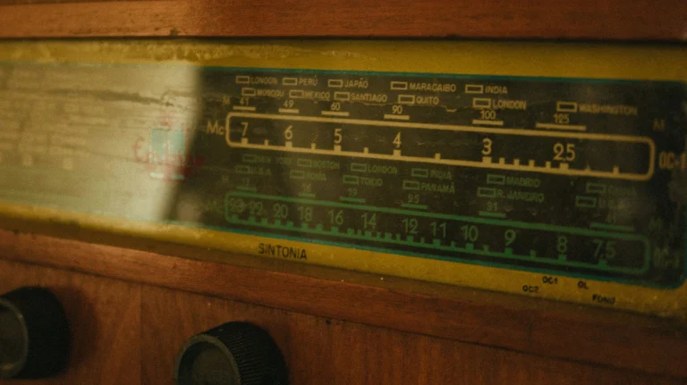 Close-up of a vintage radio tuner displaying frequency dials — an editorial image for "The Payola Scandal and the Business of Radio Airplay."