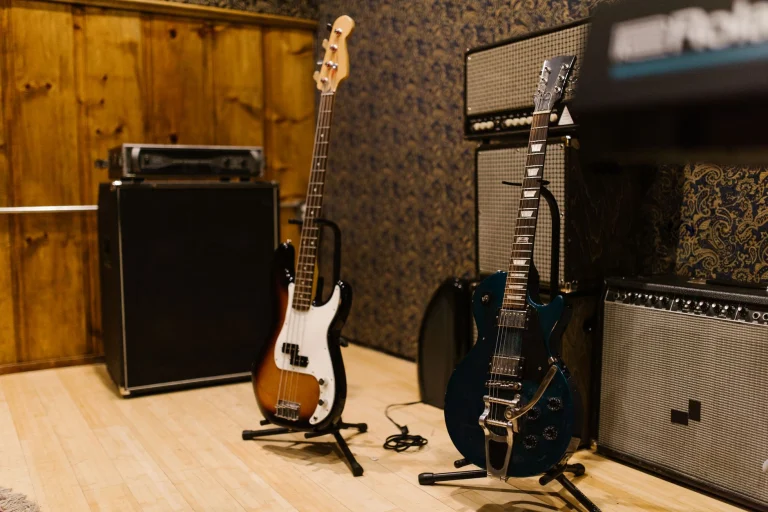 A cozy music studio featuring electric guitars and amplifiers, ideal for music production — an editorial image for "Prince: Musicianship, Independence, and Creative Control."