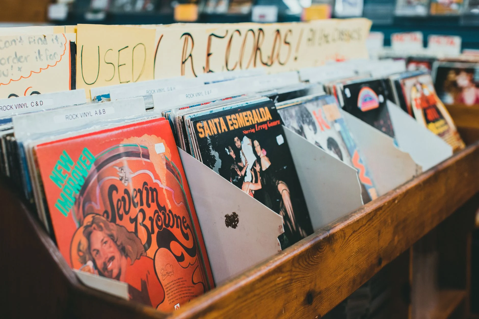 Close-up of vintage vinyl records in a music store display, emphasizing classic album covers — an editorial image for "The Record Store Era and How Fans Discovered Music."