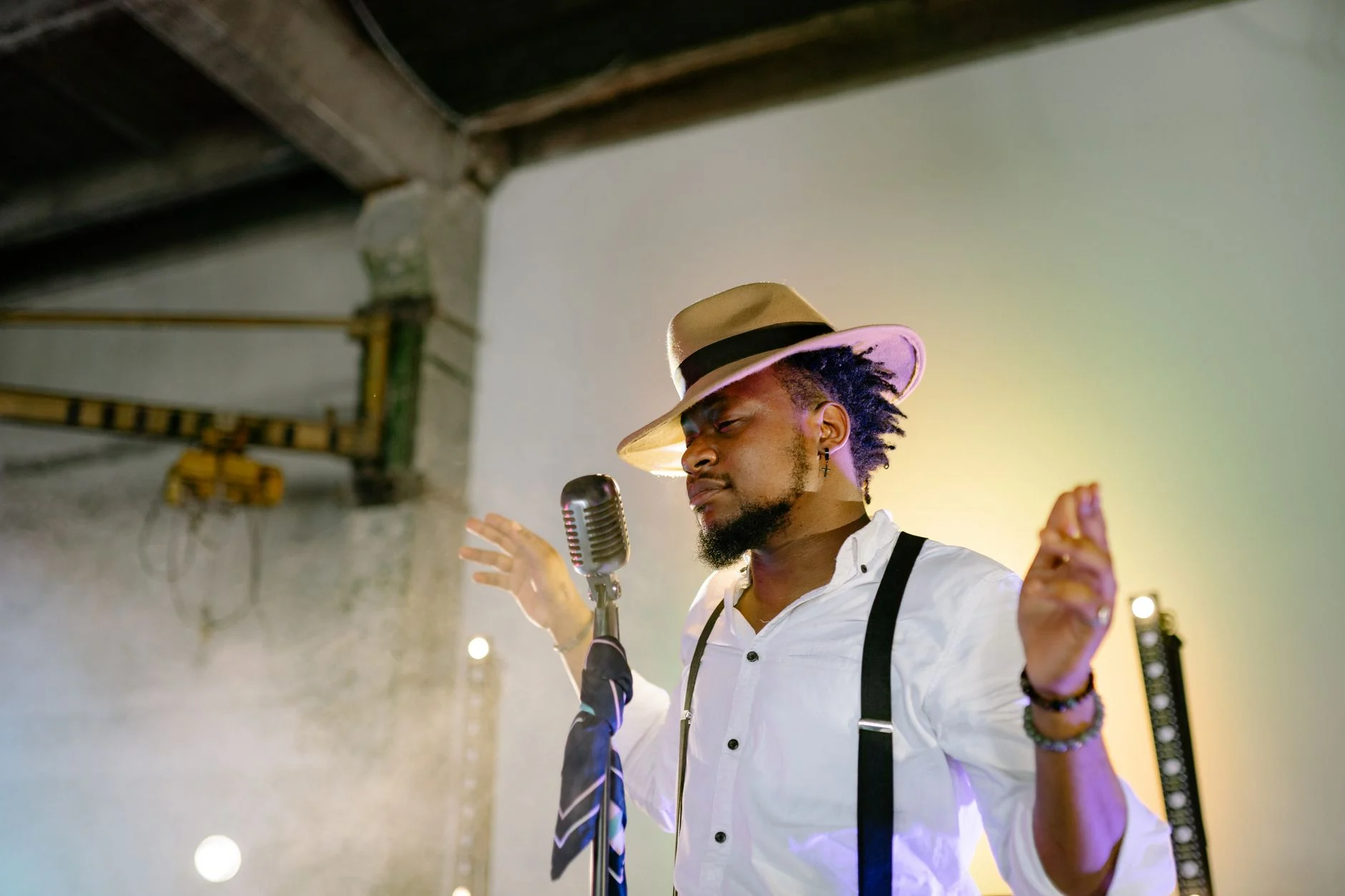 A passionate musician sings on stage with a vintage microphone and stylish hat — an editorial image for "Respect: How a Song Became a Cultural Statement."