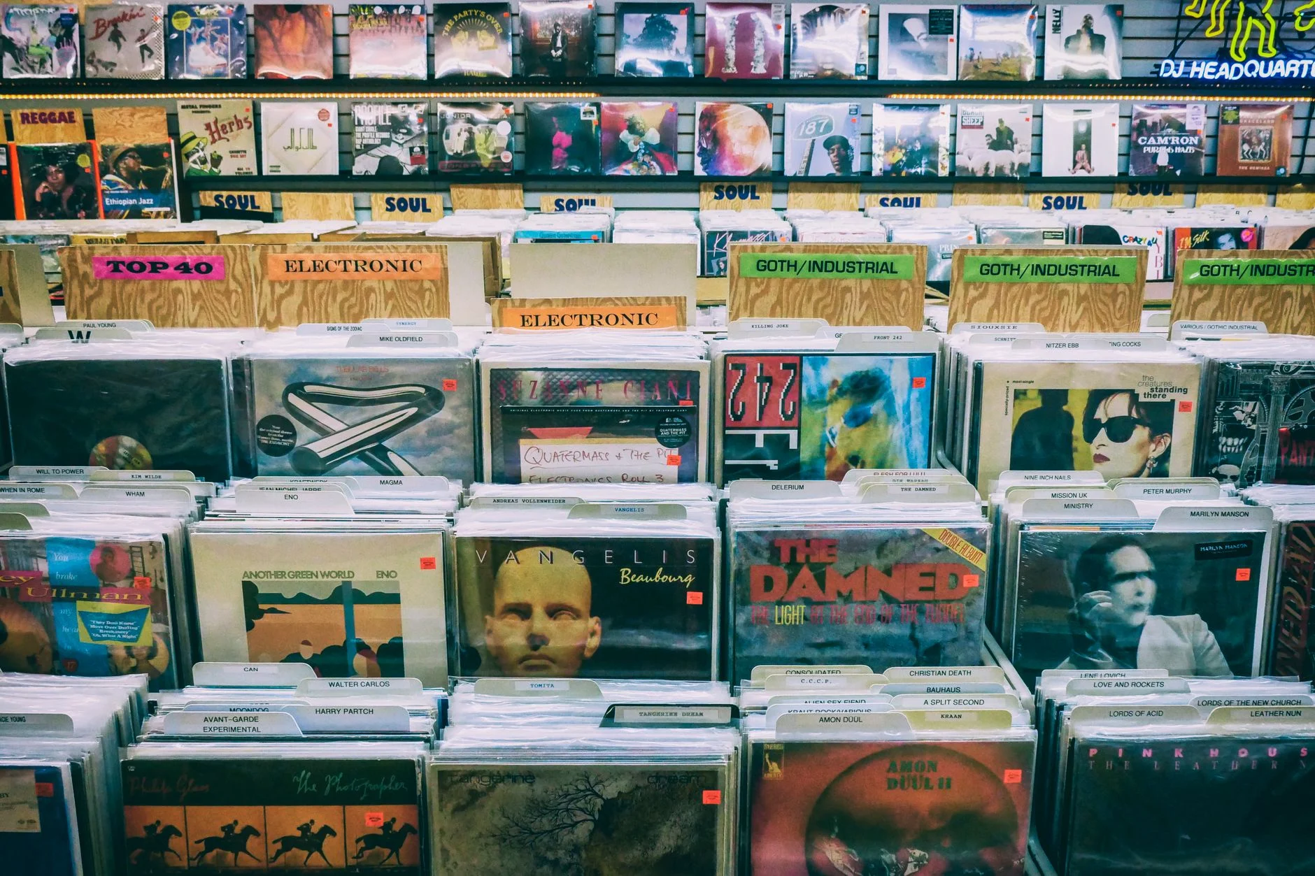 A vintage vinyl record display with diverse music genres in a classic music store — an editorial image for "The Rise of the Album as an Art Form."