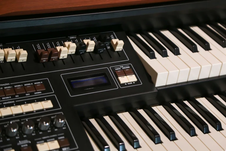 Close-up image of a vintage electric organ keyboard with control panel, featuring keys and drawbars — an editorial image for "Superstition and the Funk-Rock Crossover."