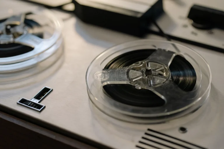 Close-up of a classic reel-to-reel tape recorder highlighting the retro aesthetic and technology — an editorial image for "Thriller: Production, Performance, and Cultural Impact."